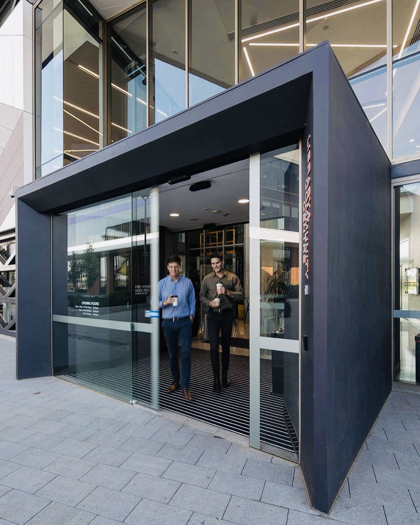 MC-125 sliding door operator installed at a commercial entrance