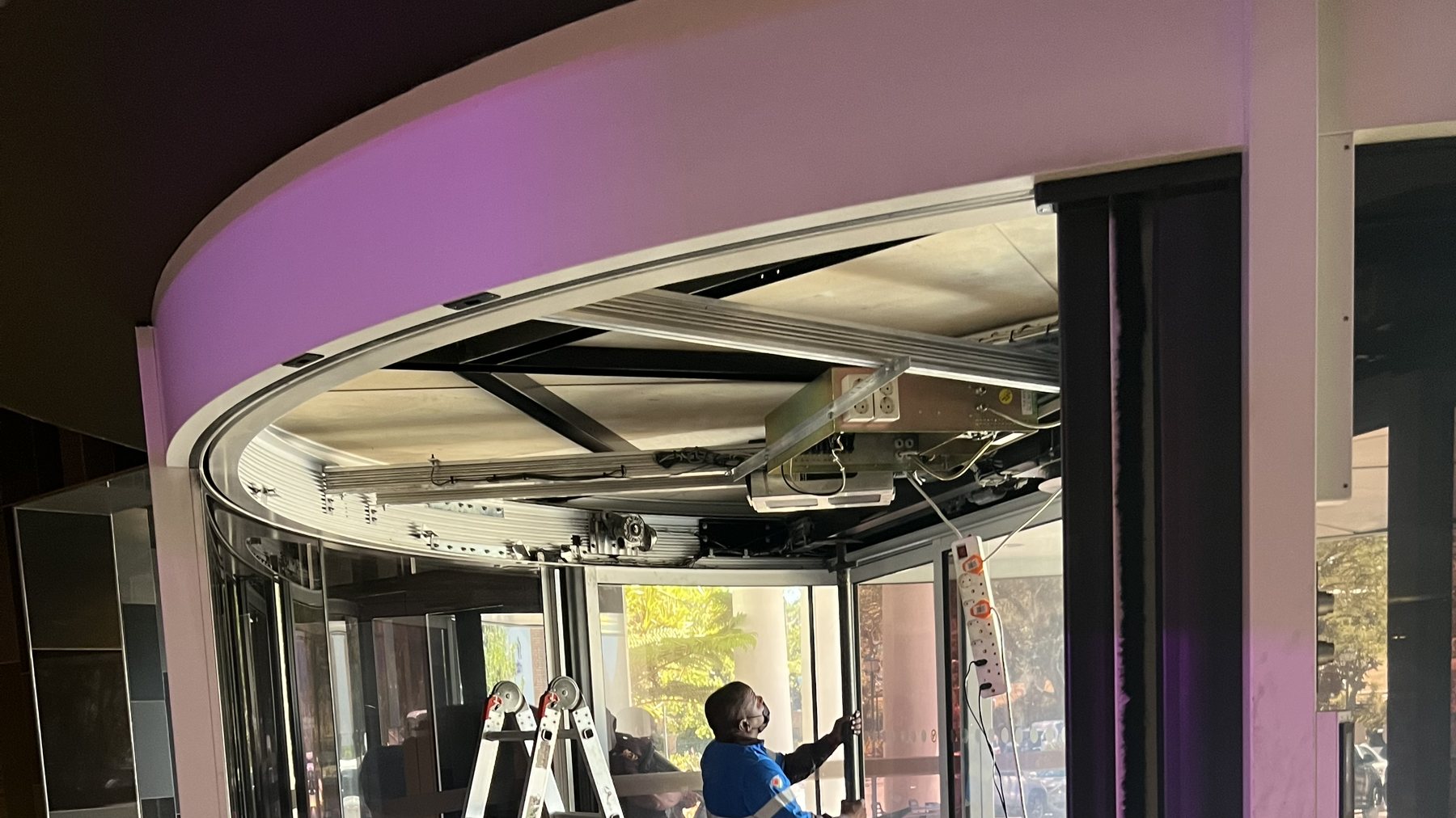 Automatic revolving doors being commissioned at a commercial lobby