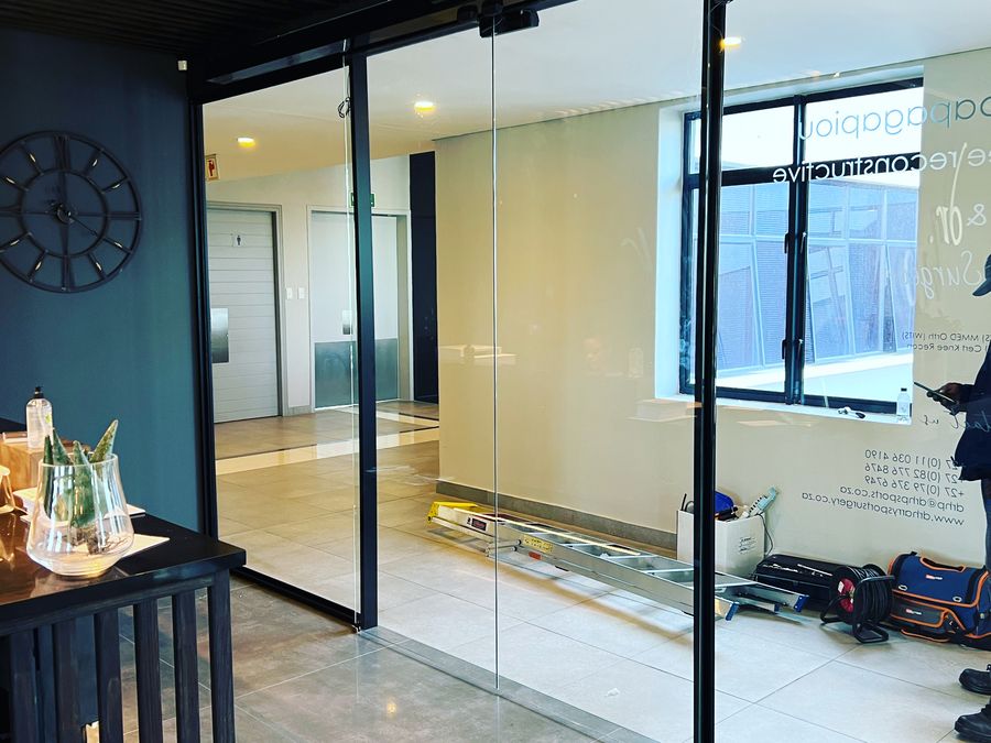 MC Automations Automatic sliding doors at a glass office entrance