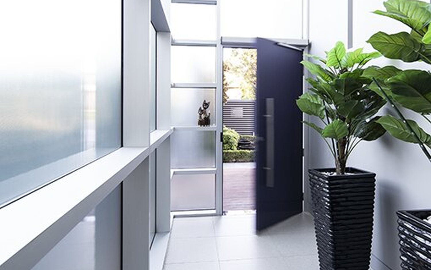Automatic swing doors open on a commercial entrance